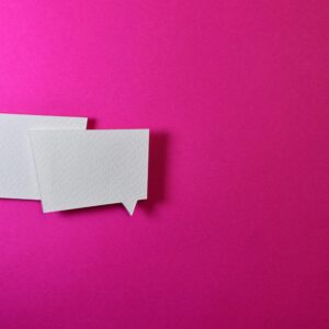 White speech bubbles on a vibrant pink background for communication or design concepts.
